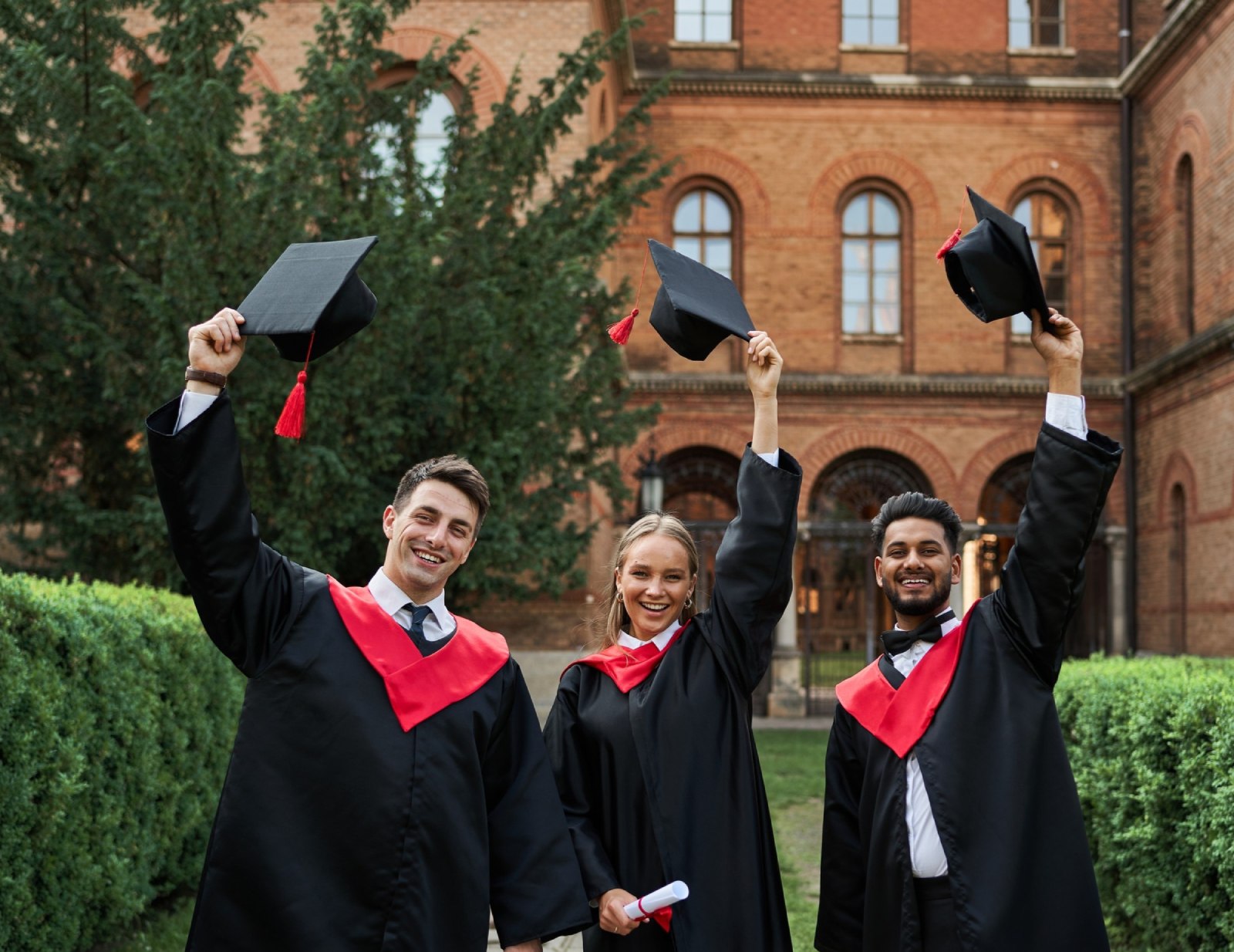 Graduates on campus — temporary image pending exact reference assets